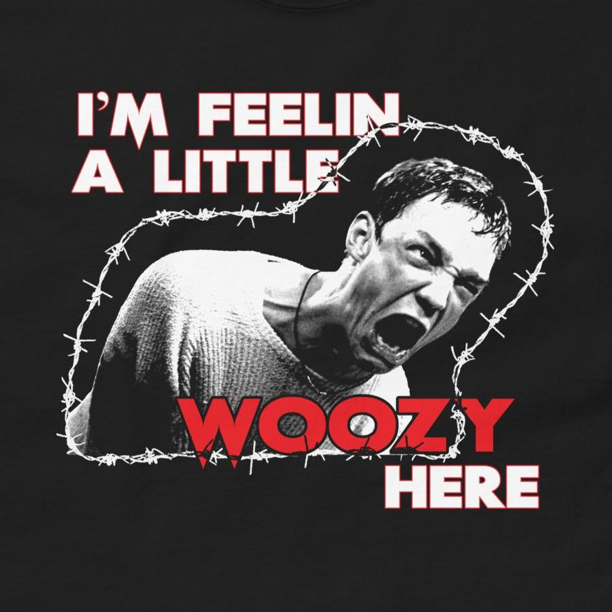 Black t-shirt with graphic design and text 'I'm feelin a little woozy here' on a white background