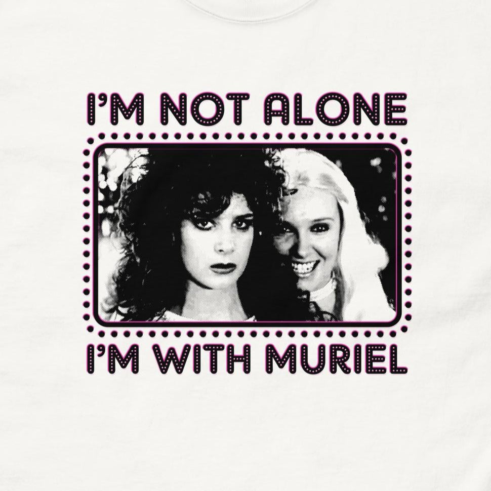 White t-shirt with graphic design and text 'I'm not alone, I'm with Muriel' on a purple background