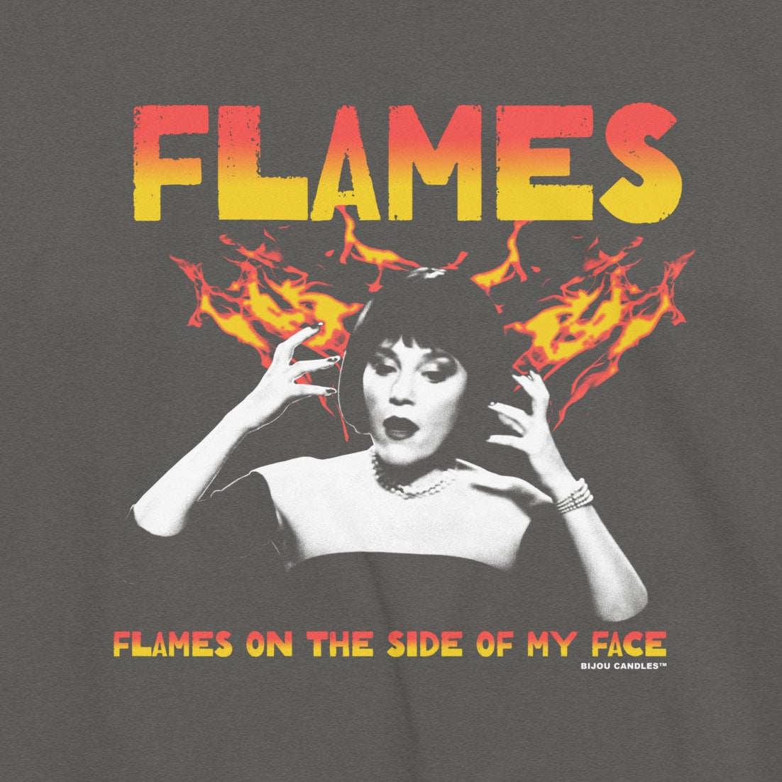 A dark gray crewneck sweatshirt featuring a vintage-style graphic print of the band Flames with their album 'Flames on the Side of My Face'. The graphic includes a black-and-white portrait of a woman, orange and yellow flames, and the band's name in orange and yellow gradient text.