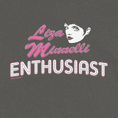 A dark gray short-sleeve t-shirt featuring a graphic print of a stylized woman's face and the text 'Liza Minnelli ENTHUSIAST' in pink and white, displayed flat against a light cream background.